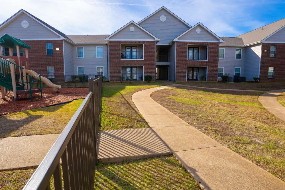 Sidewalk connecting with building at Timber Village in Marshall, Texas 