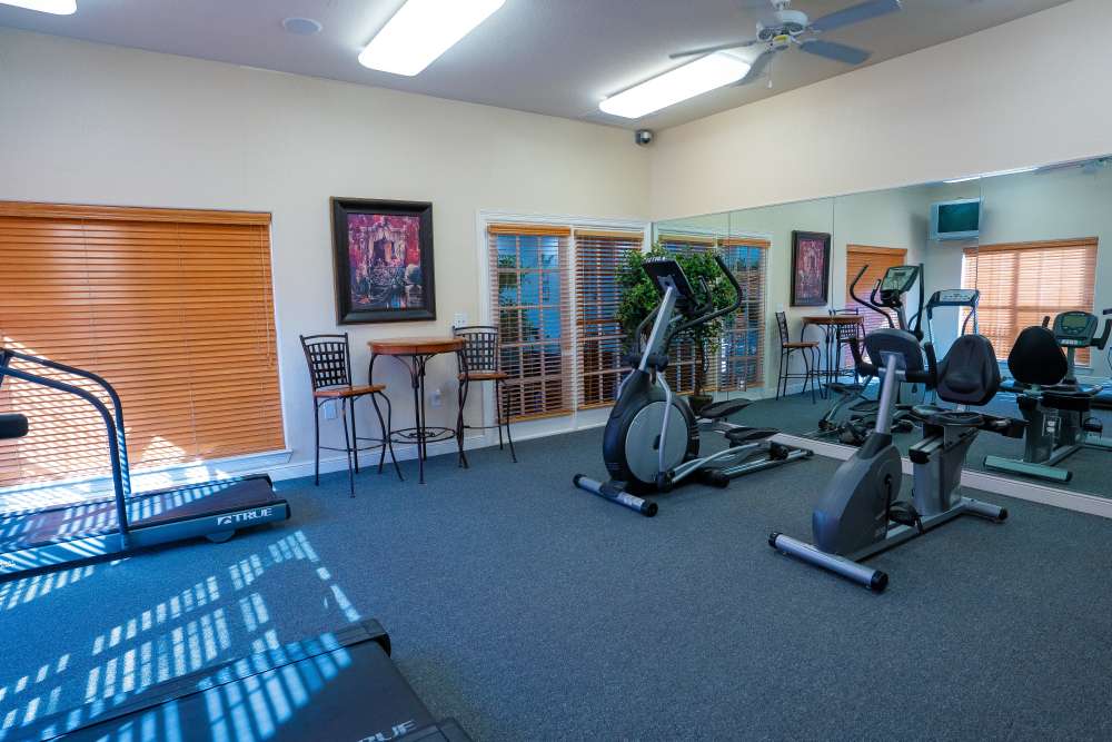 Fitness center with ceiling fan at Timber Village in Marshall, Texas