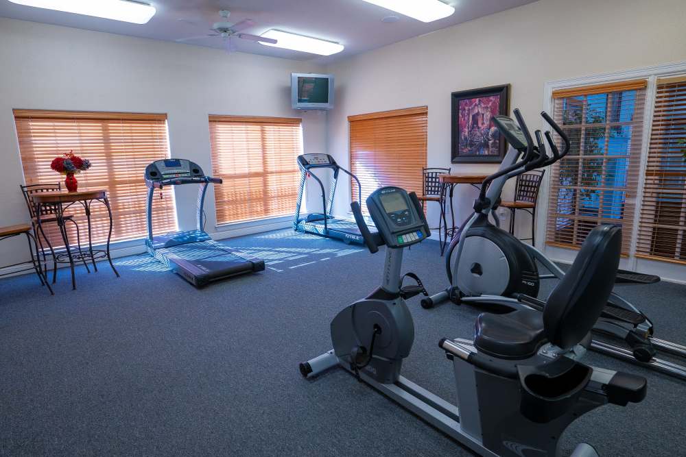 Fitness center with cardio machine at Timber Village in Marshall, Texas