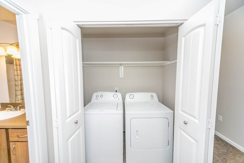 Laundry closet with white washer and dryer set at Columbia View in Vancouver, Washington