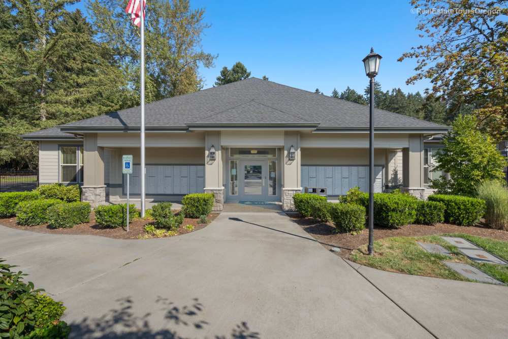 Community mail center building with walkway and landscaping at Columbia View in Vancouver, Washington