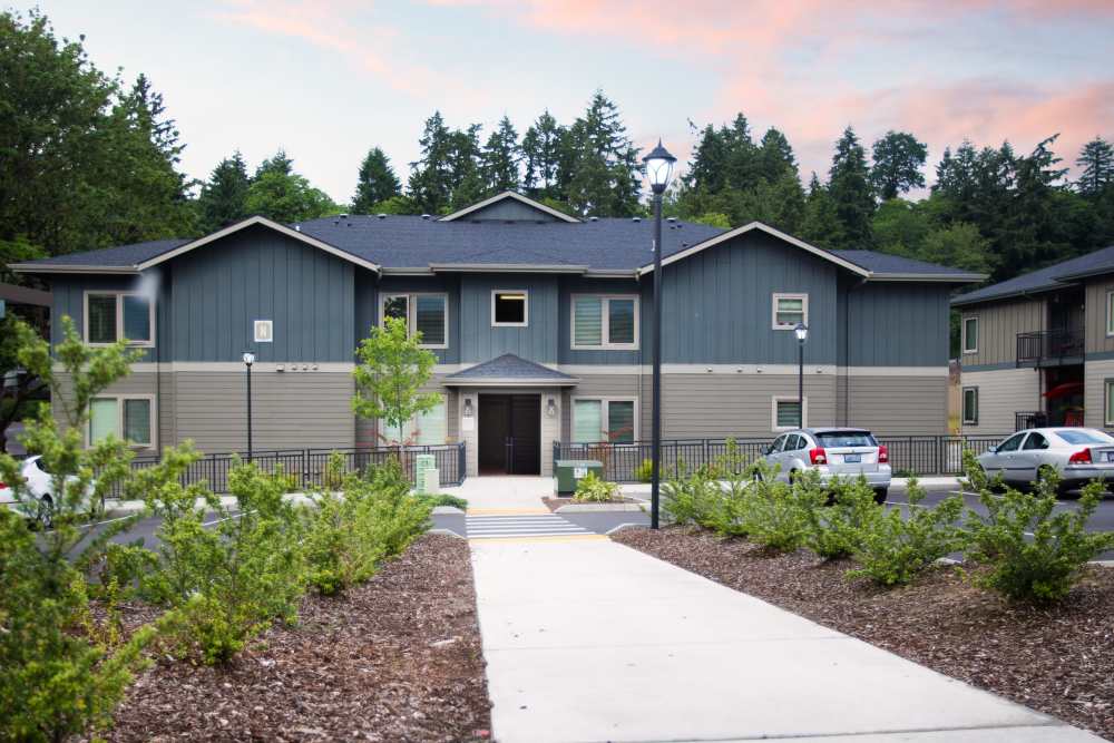Apartment building with landscaped entry path and parking area at Columbia View in Vancouver, Washington