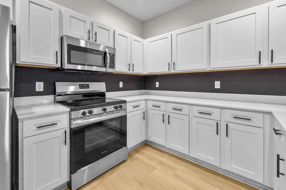 stainless appliances and white cabinetry in kitchen at Pointe 28 in Ankeny, Iowa.