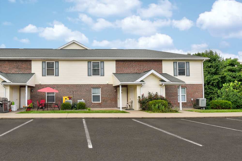 Apartment exterior with parking at Cedar Glen II in Morgantown, West Virginia