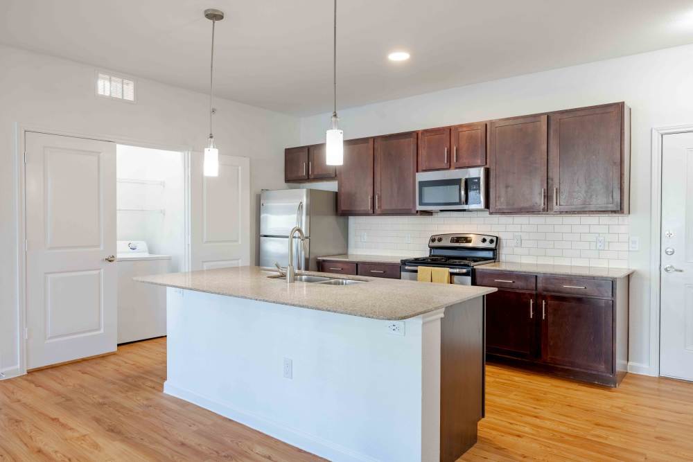 Modern apartment kitchen with stainless steel appliances and large island in Austin, Texas