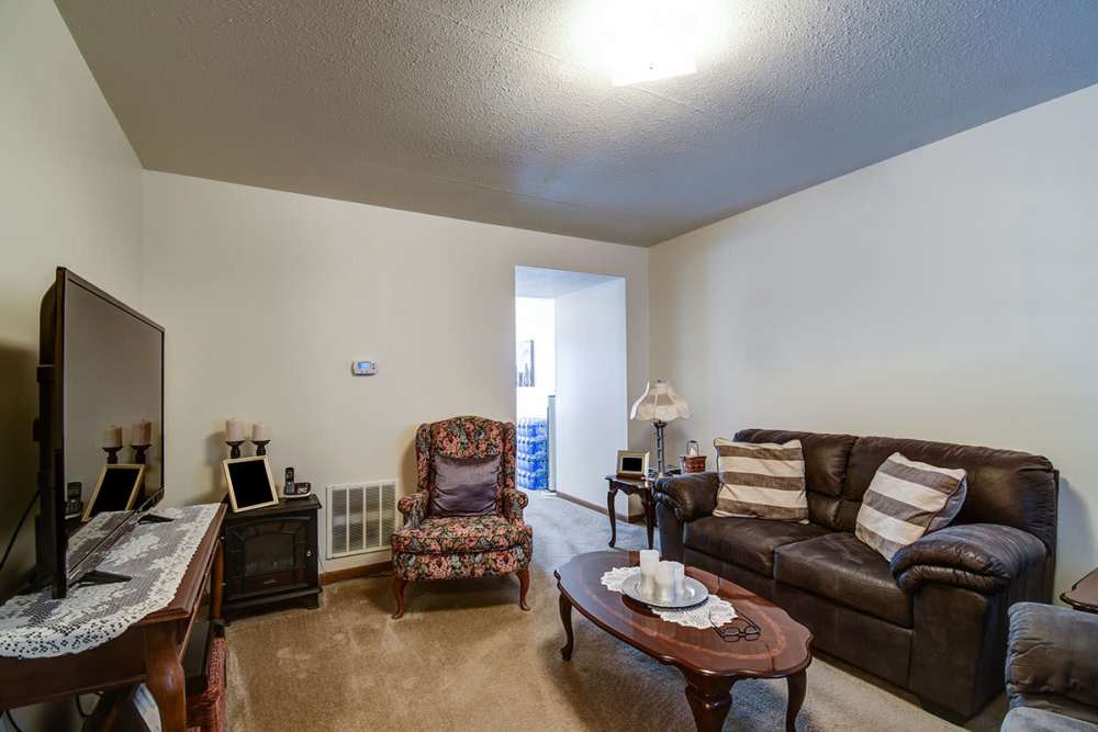 Comfortable living room with sofa and TV at Muirwood Greene in Romney, West Virginia