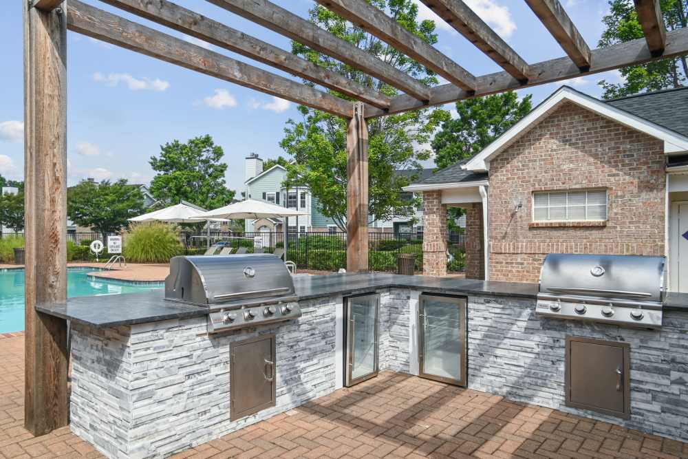 Outdoor grilling area beside the pool at Highlands at Alexander Pointe in Charlotte, North Carolina