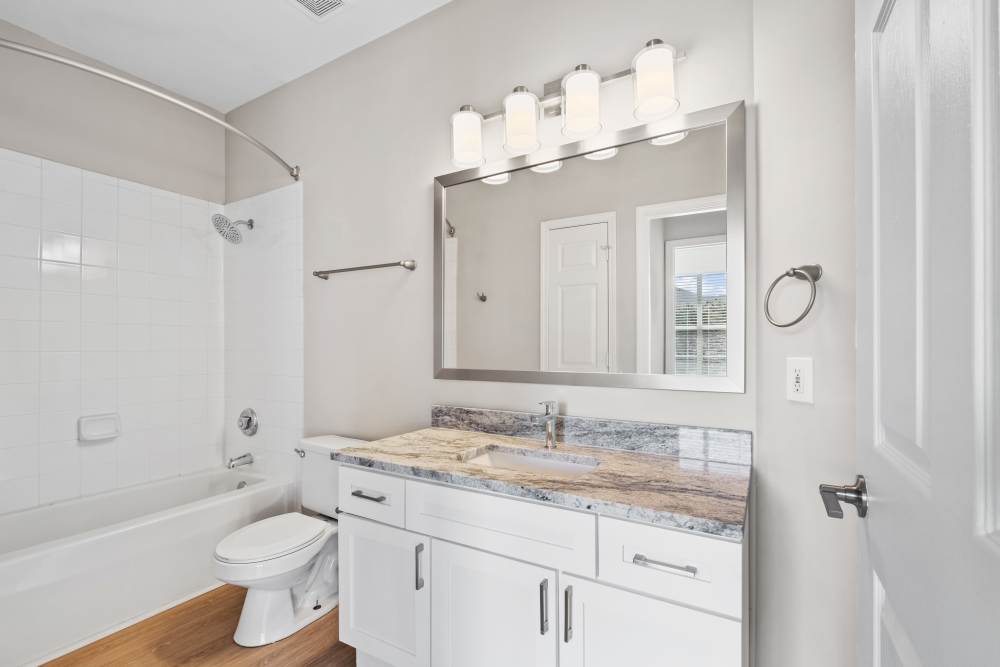 Bathroom with storage vanity sink and mirror at Highlands at Alexander Pointe in Charlotte, North Carolina