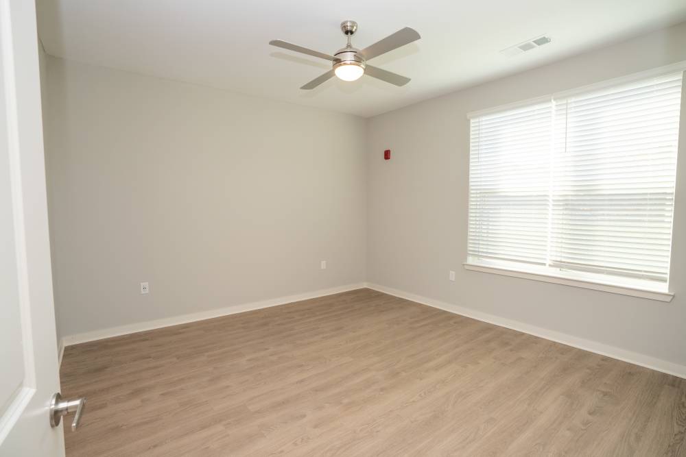 Spacious bedroom with ceiling fan at Donerail Run in Louisville, Kentucky