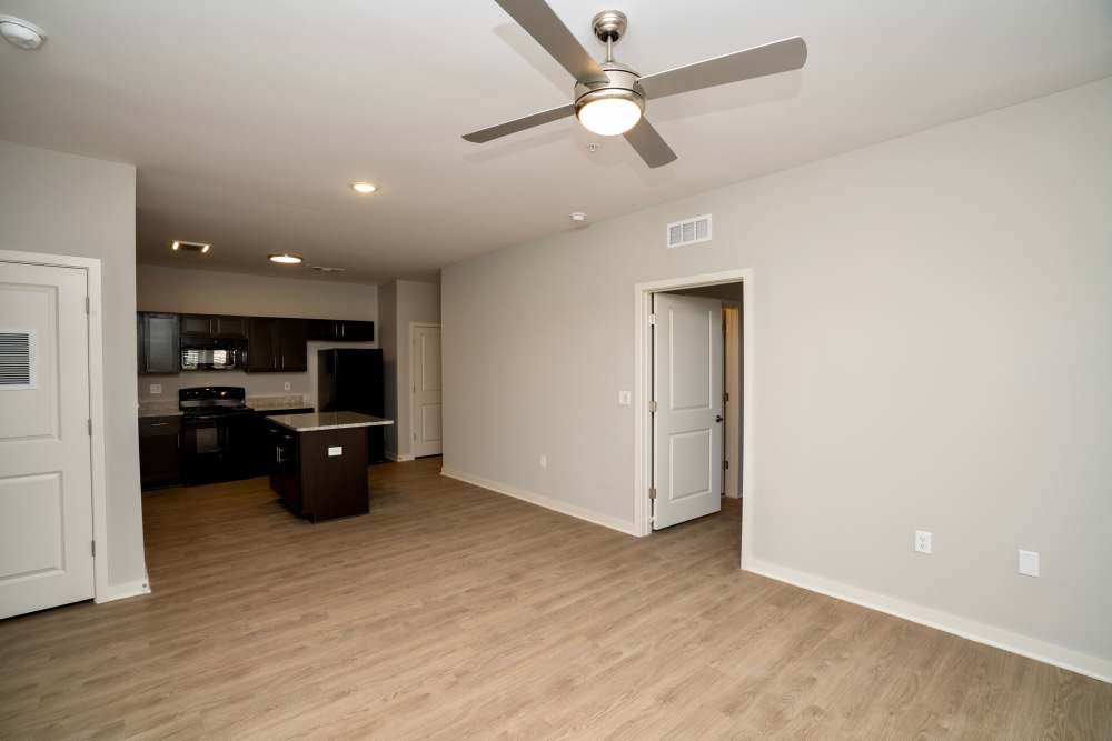 Living room with connecting kitchen at Donerail Run in Louisville, Kentucky