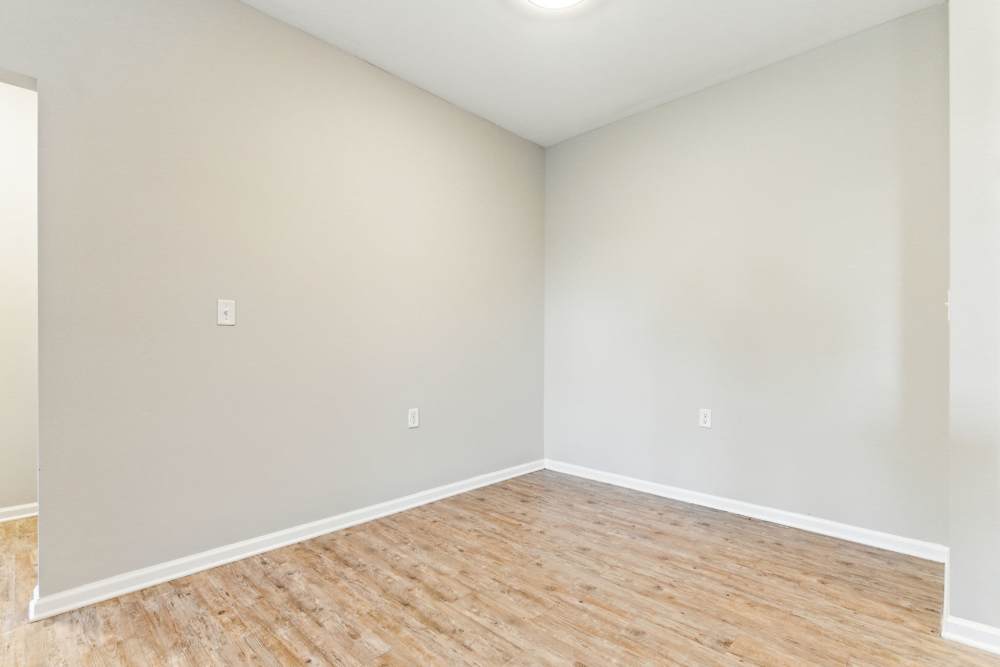 Spacious dining room with wood-style flooring at Bristol Bluffs Apartments in Louisville, Kentucky