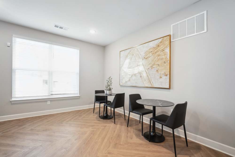 Bright dining area with wood-style flooring in the common space at Lone Oak Meadows in Louisville, Kentucky