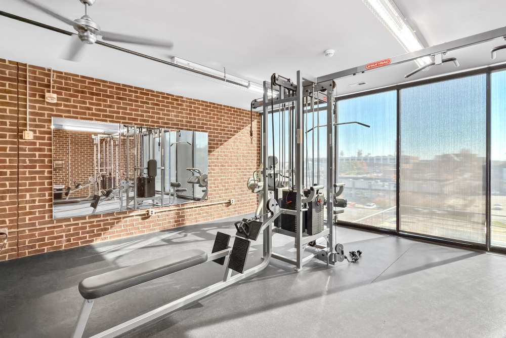 Bright fitness center with large windows at Ingersoll Square in Des Moines, Iowa
