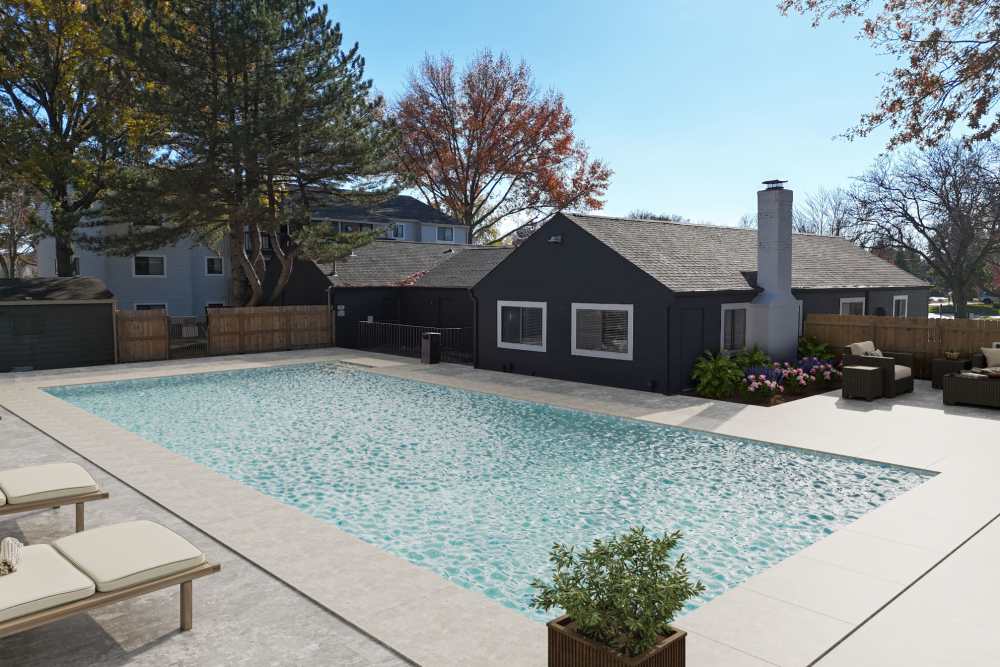 Swimming pool with clubhouse surrounded by trees at Rock Ridge Commons in Moline, Illinois
