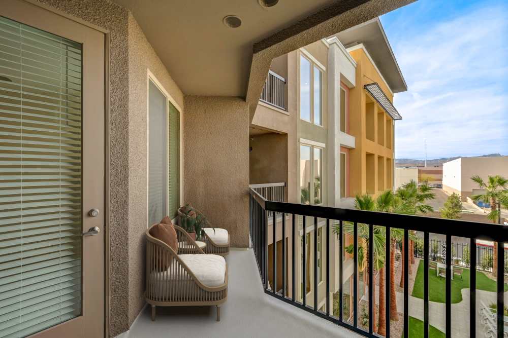 Covered balcony with seating and courtyard view at Heirloom at Torrey Pines in Las Vegas, Nevada