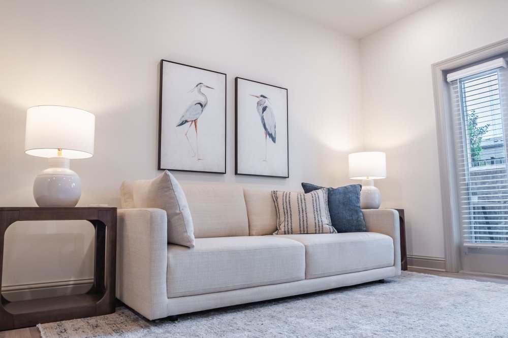 White couch and table lamps in the living room at The Heights at Waterpointe in Flowood, Mississippi