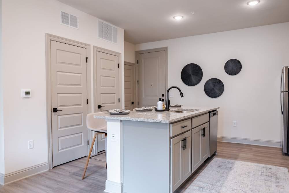 Kitchen island with granite countertops at The Heights at Waterpointe in Flowood, Mississippi