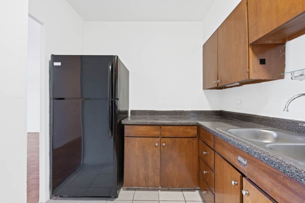 Kitchen with granite countertops and black appliances at Central Gardens in Memphis, Tennessee