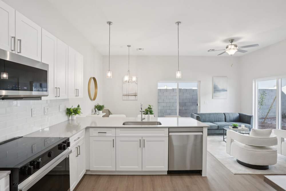 A modern kitchen with white cabinets and a large island.