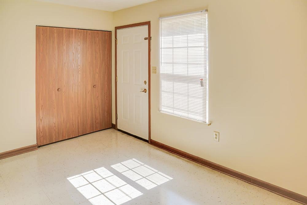 Bright entryway with natural light, wood-style flooring, and spacious closet doors at Arlington Greene in London, Kentucky
