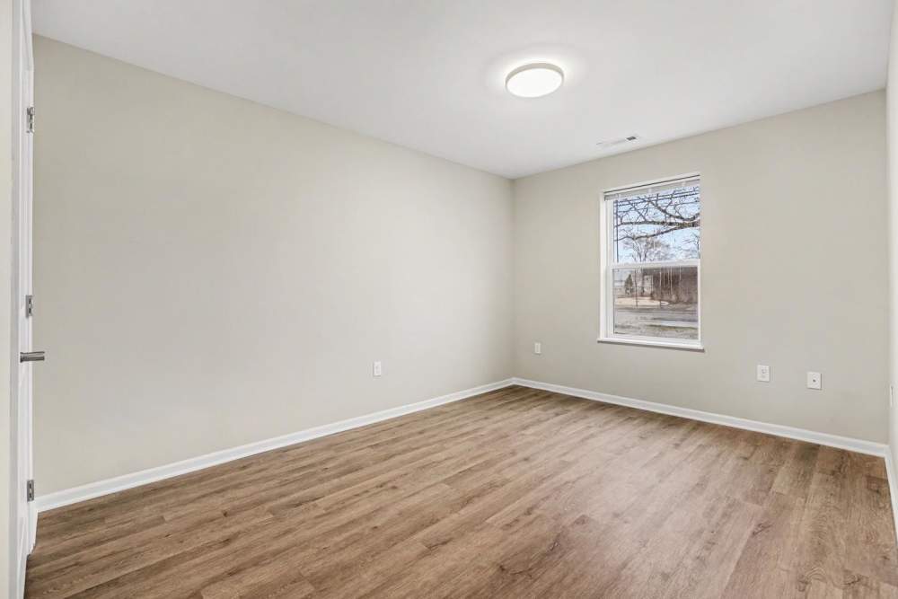 Empty bedroom with wood-style flooring and a window providing natural light at Annika Place II in Traverse City, Michigan
