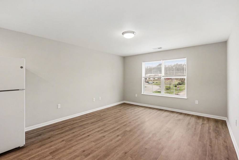 Spacious living area with large windows for natural light at Bridlewood Crossing in Louisville, Kentucky