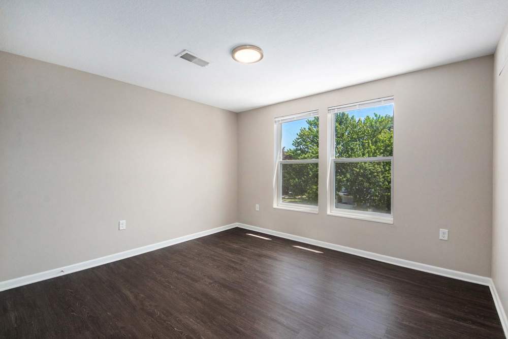 Spacious room with wood-style flooring and large windows providing natural light at Seven45 Stocking in Grand Rapids, Michigan