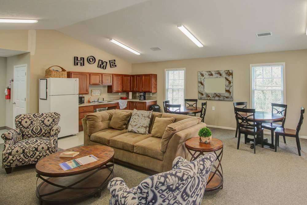 Cozy living area with plush seating, dining table, and modern kitchen appliances at Pennington Crossing in Johnson City, Tennessee