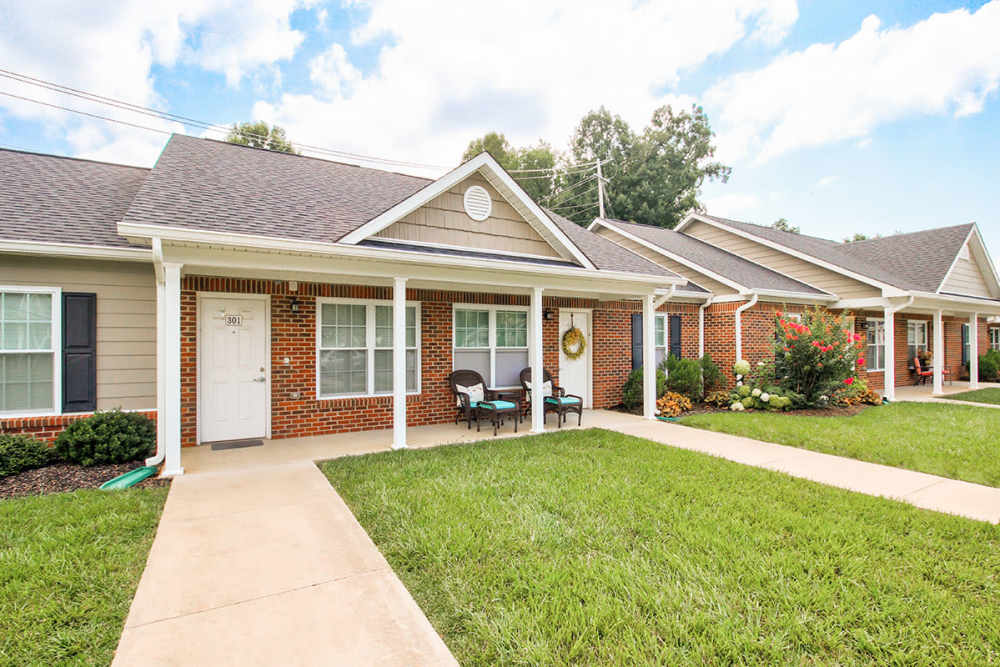 Charming apartment community with inviting porches and well-maintained landscaping at Pennington Crossing in Johnson City, Tennessee