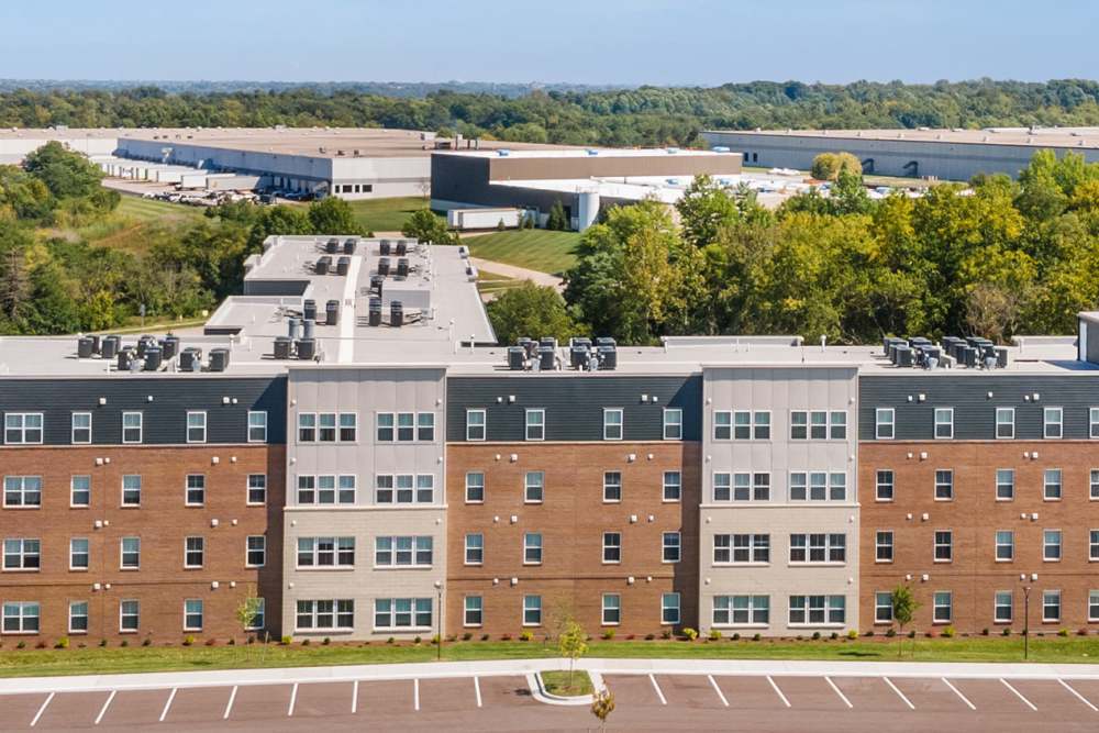 Modern apartment community with landscaped grounds and ample parking spaces at Sparrow Ridge in Hebron, Kentucky