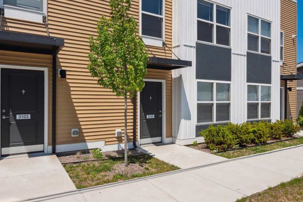 Modern apartment community with welcoming entrances and landscaped greenery at Winston Commons in Pontiac, Michigan