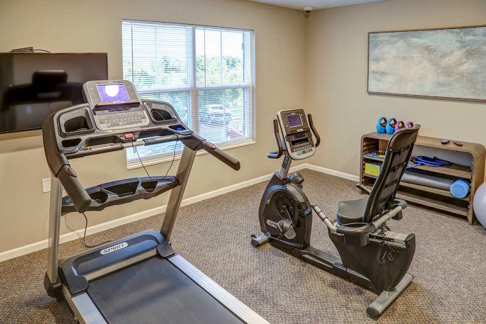 Fitness center with treadmill and stationary bike, large window providing natural light at Tristan Ridge in Eminence, Kentucky