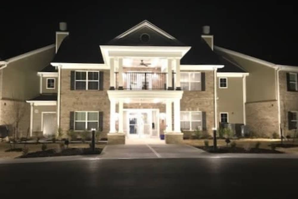 Well-lit apartment community entrance with welcoming porch and landscaped surroundings at Tristan Ridge in Eminence, Kentucky