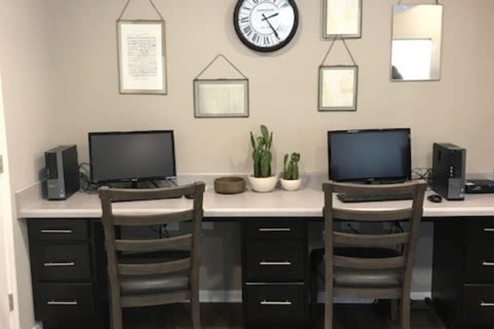 On-site office with two computers, modern desk, and decorative plants on countertop at Tristan Ridge in Eminence, Kentucky