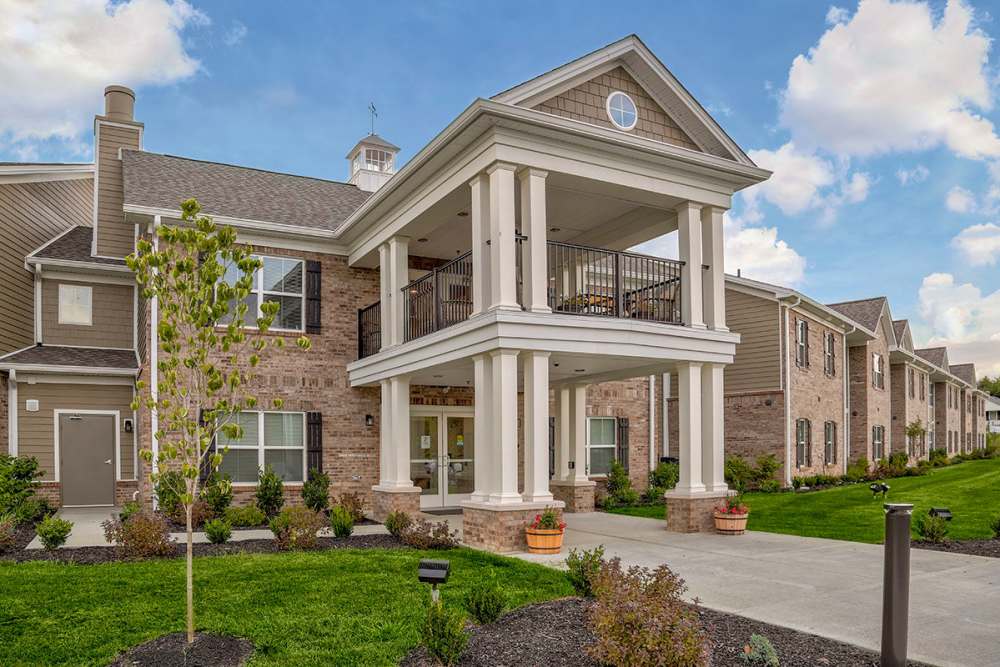 Gated entrance with landscaped greenery and a welcoming porch area at Tristan Ridge in Eminence, Kentucky
