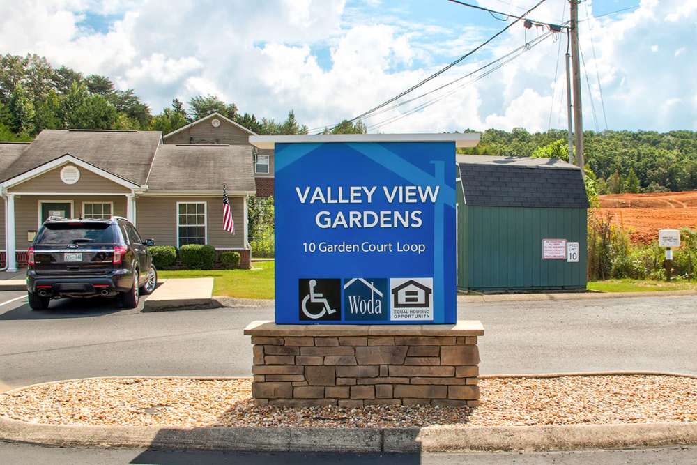 Sign for Valley View Gardens with landscaped entrance and parking area at Valley View Gardens in Dunlap, Tennessee