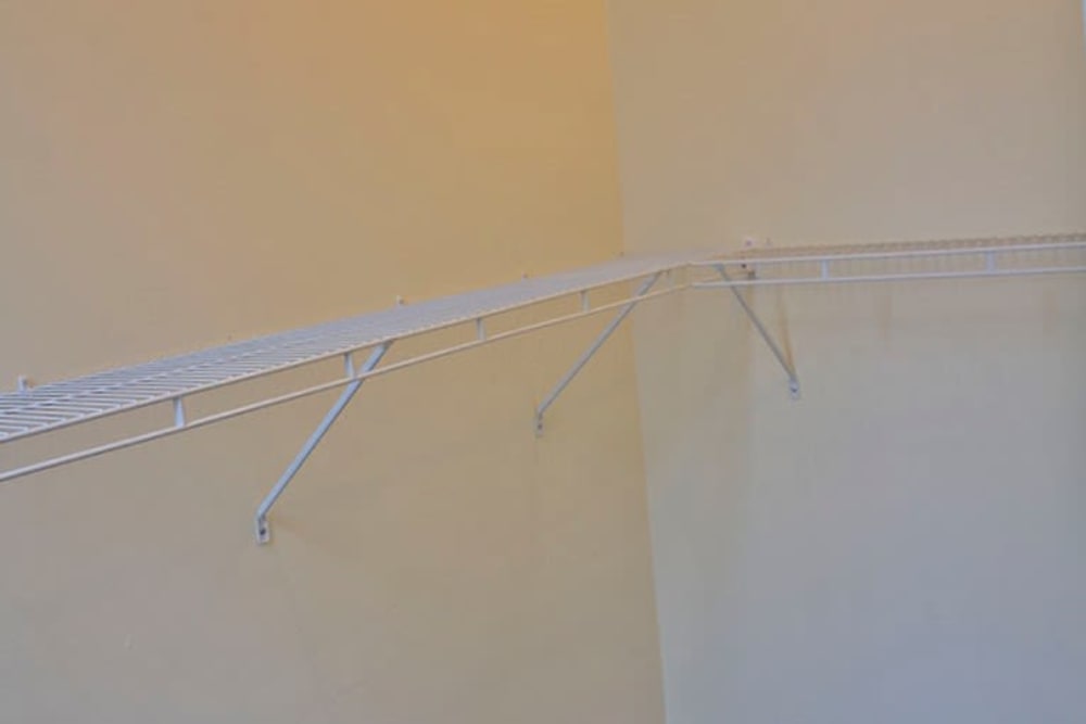 Wire shelving unit mounted on a light-colored wall in a spacious closet at Lincoln House in Owosso, Michigan