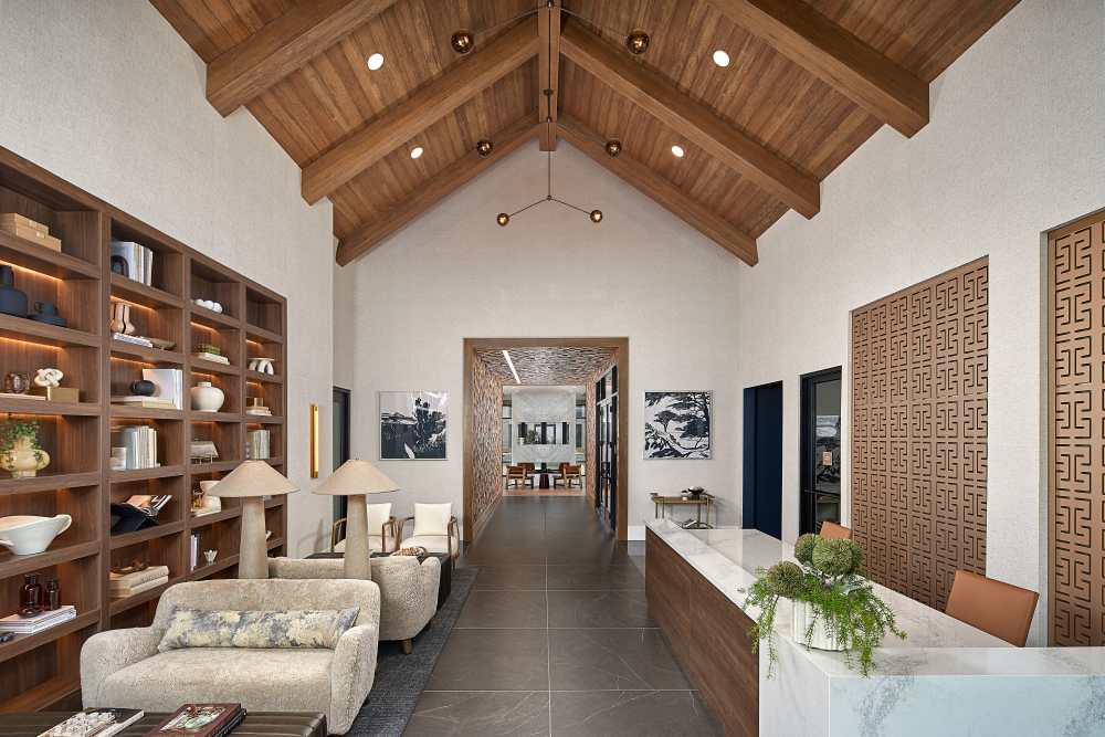 Lobby view with reception desk, vaulted wood ceiling, and seating area at The Millwright in Cornelius, North Carolina
