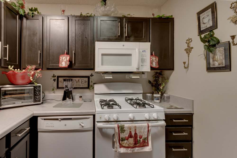 Modern kitchen with dark cabinets, stainless steel appliances, and decorative accents at 123 Club in Beaufort, South Carolina