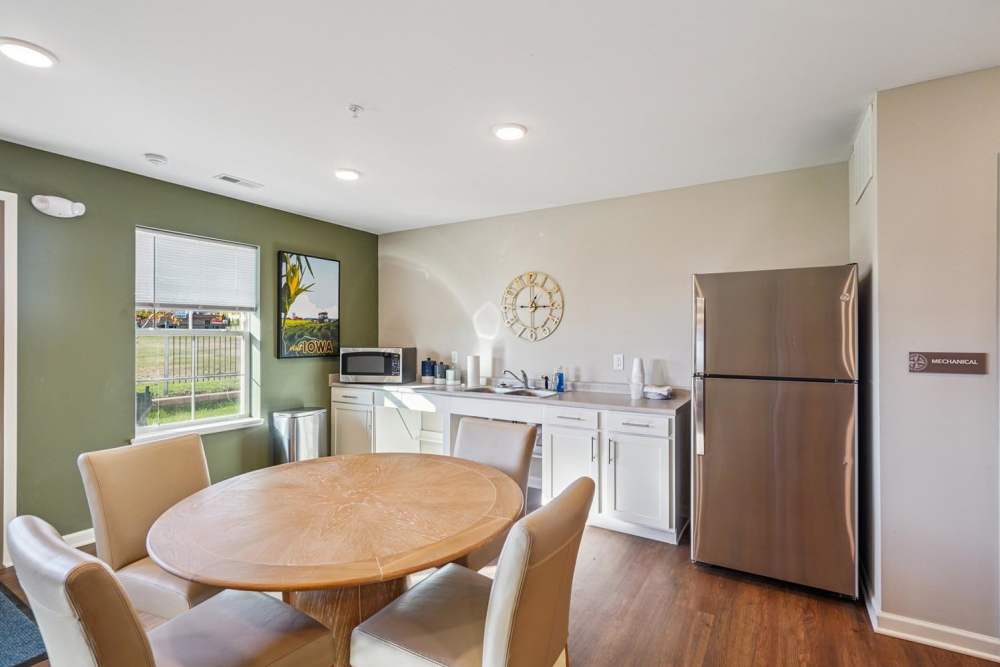 Modern kitchen with stainless steel appliances and dining table at Alley Landing in Des Moines, Iowa