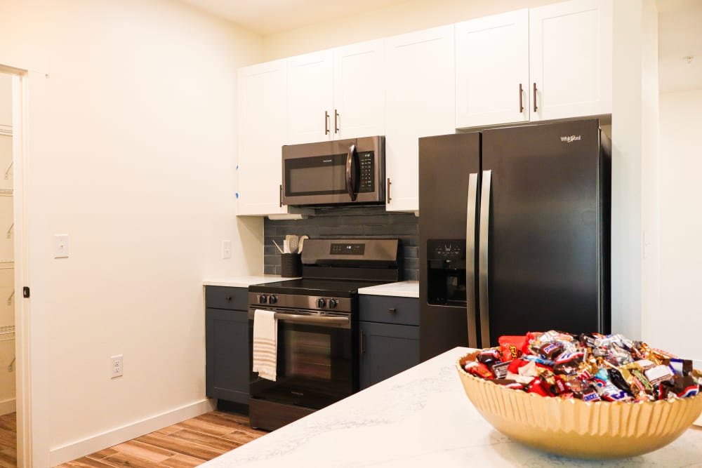 Modern kitchen with stainless steel appliances at Copper Trail Townhomes in Owasso, Oklahoma