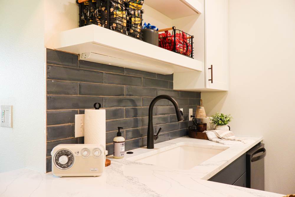 Modern kitchen with granite countertops and sink at Copper Trail Townhomes in Owasso, Oklahoma