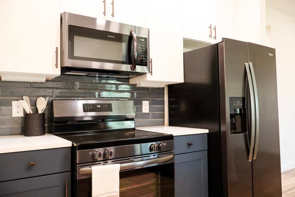 Stainless steel appliances with granite countertops at Copper Trail Townhomes in Owasso, Oklahoma