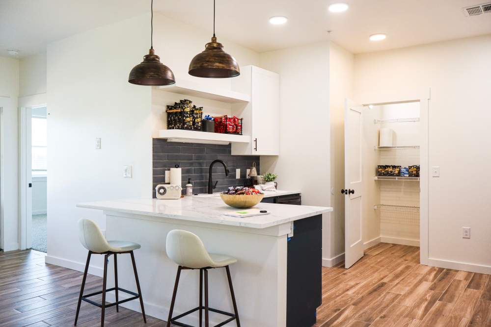 Modern kitchen with granite countertops and island at Copper Trail Townhomes in Owasso, Oklahoma