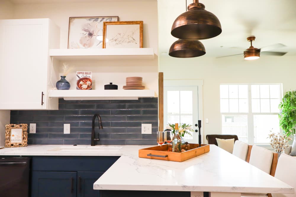 Modern kitchen with granite countertops and island at Copper Trail Townhomes in Owasso, Oklahoma