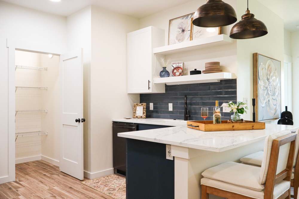 Modern kitchen with granite countertops and island at Copper Trail Townhomes in Owasso, Oklahoma