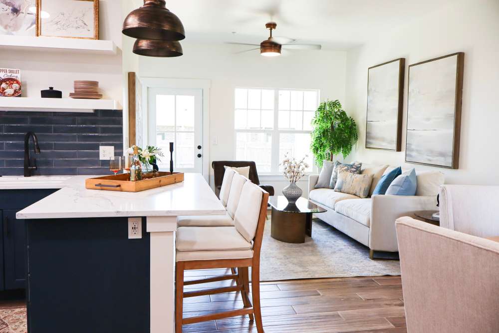 Open layout with modern kitchen and cozy living room at Copper Trail Townhomes in Owasso, Oklahoma