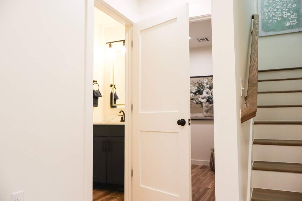 Stylish bathroom entrance with wood-style flooring at Copper Trail Townhomes in Owasso, Oklahoma