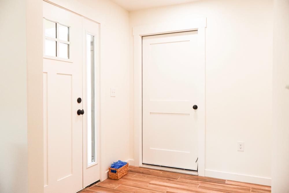 Bright entryway with wood-style flooring at Copper Trail Townhomes in Owasso, Oklahoma