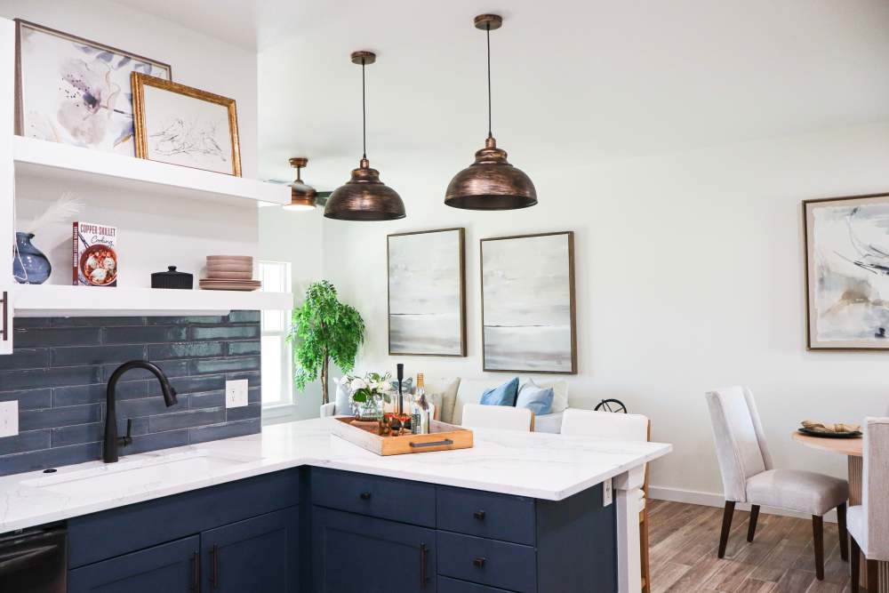 Stylish kitchen with pendant lights and island at Copper Trail Townhomes in Owasso, Oklahoma